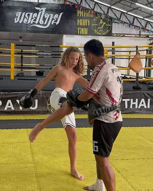 Teen trainee holding pads during training at PM PAYU Muaythai, Koh Samui